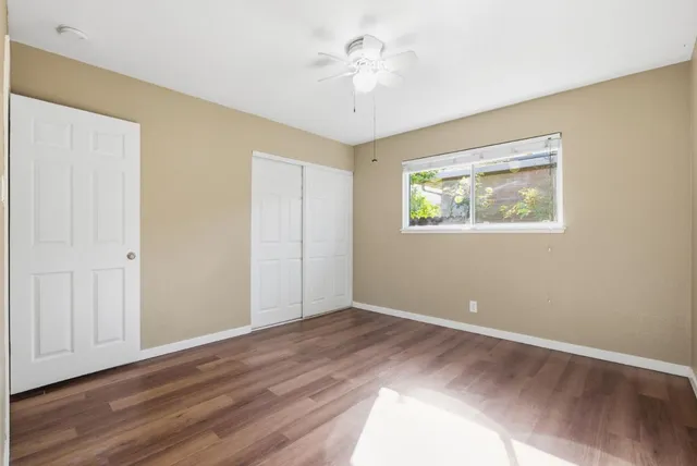 a view of room with window and ceiling fan