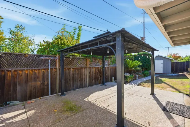a backyard of a house with a fountain table and chairs