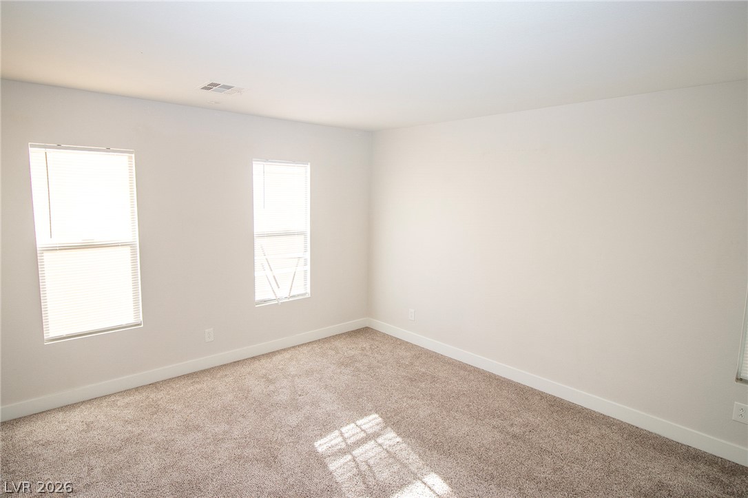 1468 Reef Ridge Court Las Vegas, NV 89128 - Photo 10 of 22 Natural light streams into this generously sized room, ready for your personal touch.