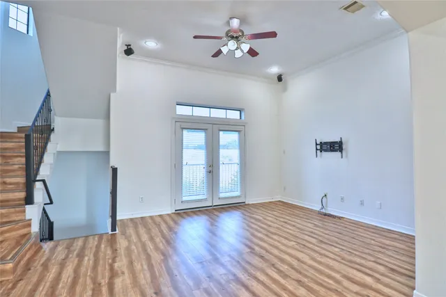 wooden floor in an empty room with a window