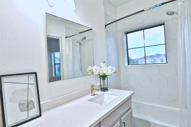 a bathroom with a granite countertop toilet sink and mirror