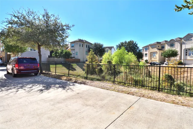 a backyard with potted plants and wooden fence