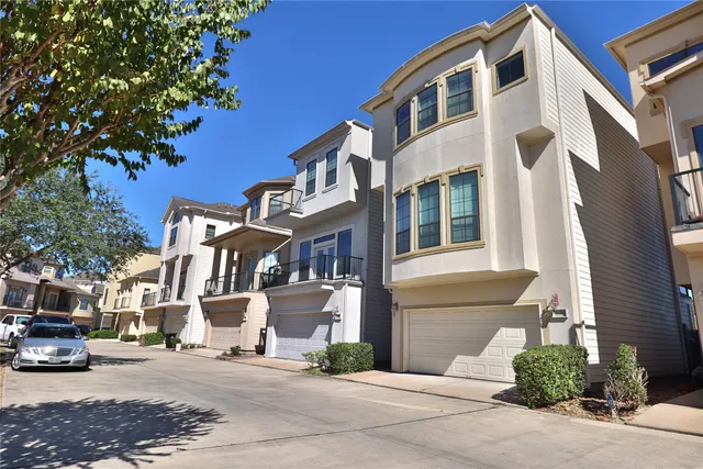a very nice looking room with a large bed a rug and a chandelier