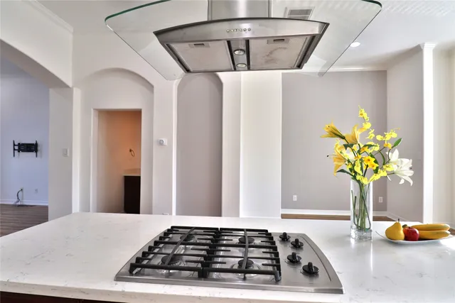 a kitchen with stainless steel appliances granite countertop a refrigerator stove and oven