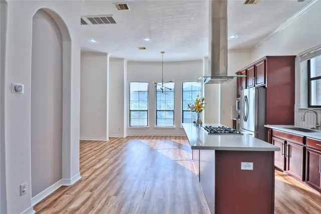 a kitchen with stainless steel appliances granite countertop wooden cabinets and a counter top space