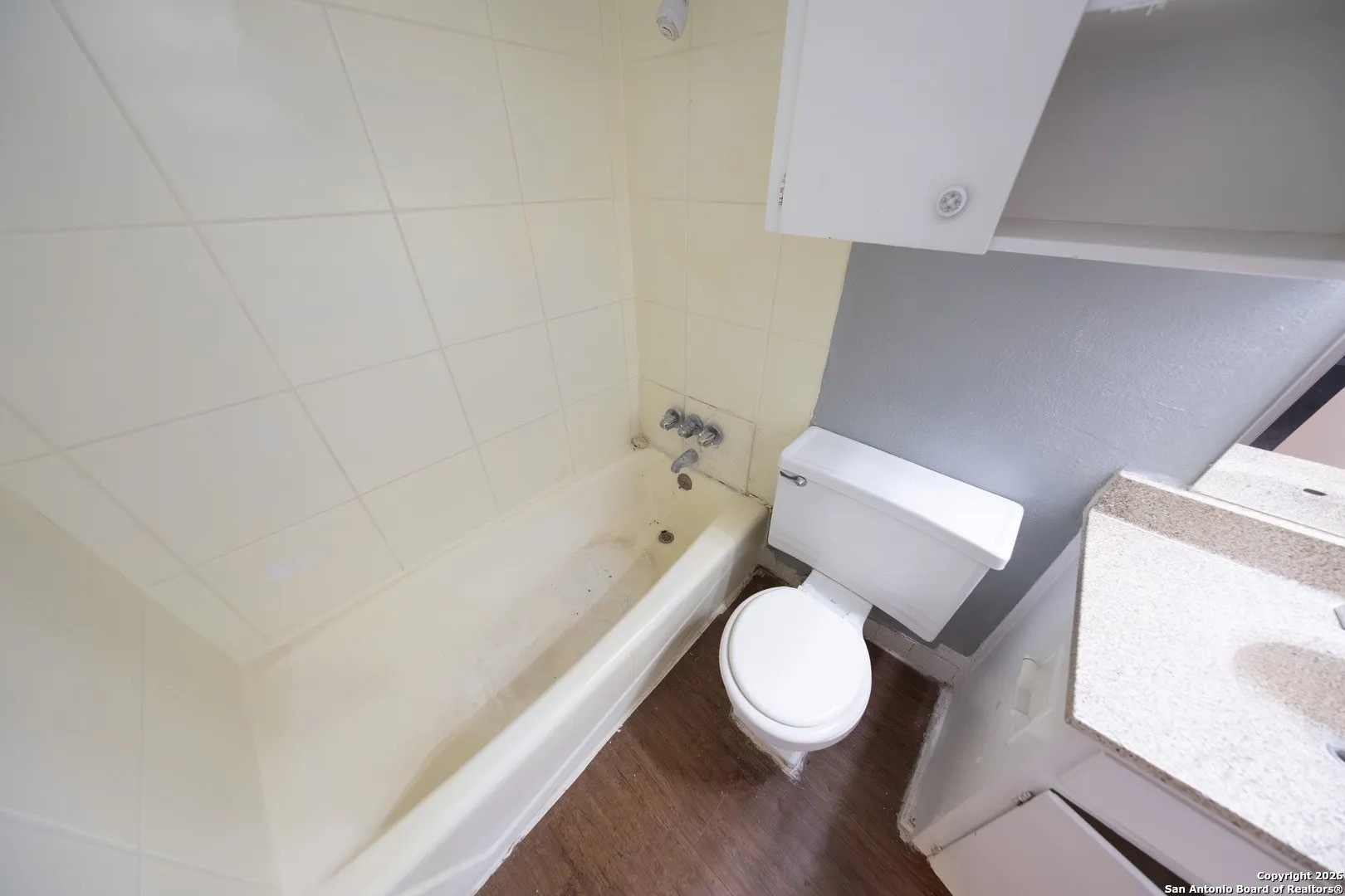 170 De Chantle Road, Unit 709 San Antonio, TX 78201 - Photo 23 of 24 a white toilet sitting next to a bath tub