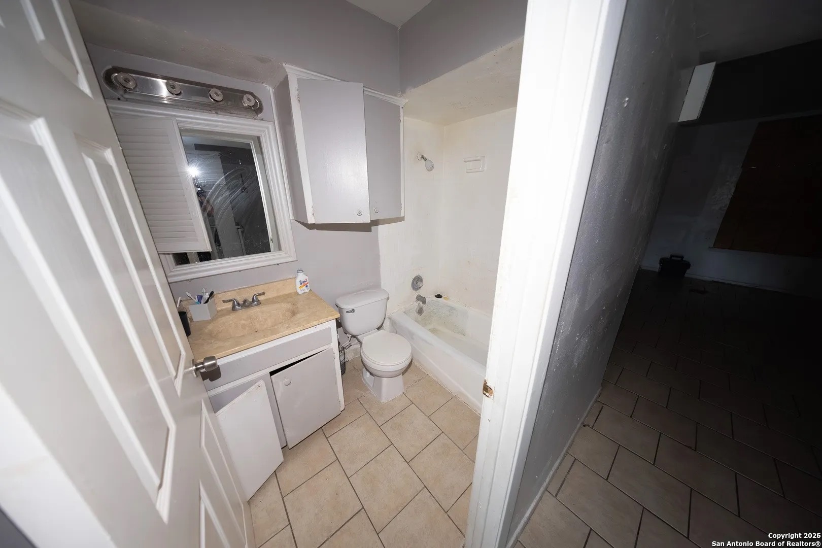 170 De Chantle Road, Unit 709 San Antonio, TX 78201 - Photo 9 of 24 a bathroom with a granite countertop sink and a mirror