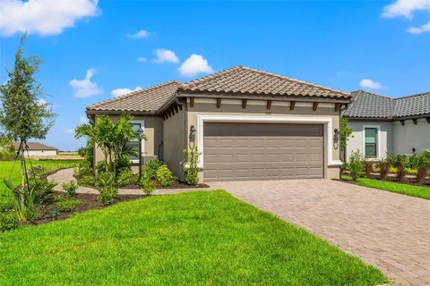 a front view of a house with a garden and yard
