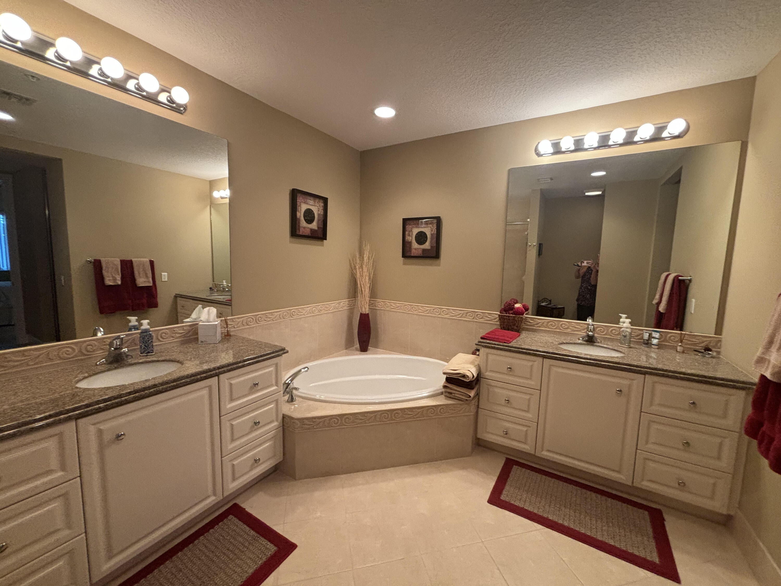 9 Harbour Isle Drive East, Unit PH5 Fort Pierce, FL 34949 - Photo 19 of 27 a bathroom with a double vanity sink mirror and bathtub