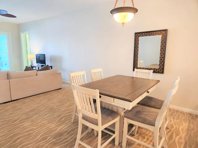 a living room with a table and a chandelier