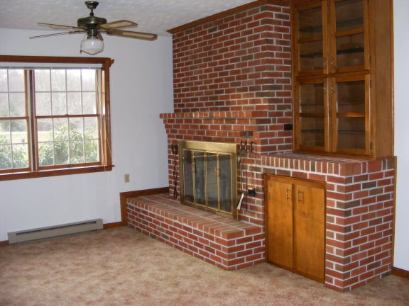 227 Remington Road Southeast Floyd, VA 24091 - Photo 7 of 11 a living room with a fireplace and a window