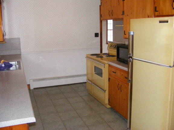 227 Remington Road Southeast Floyd, VA 24091 - Photo 8 of 11 a kitchen with a refrigerator sink stove and cabinets