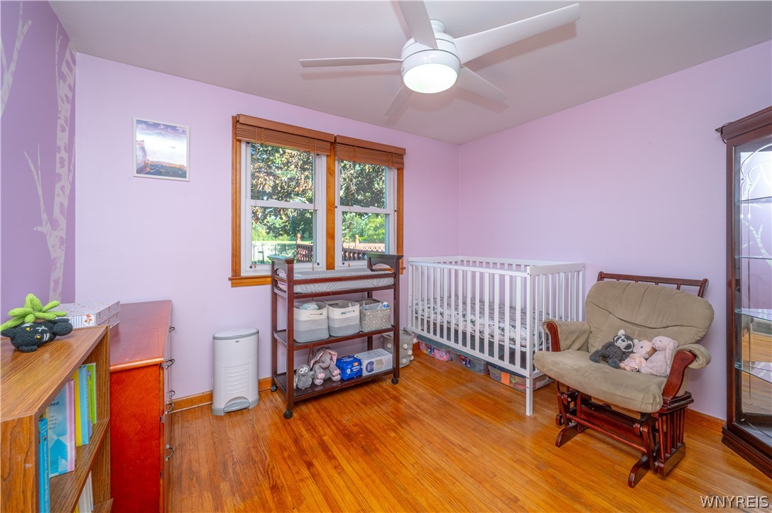 6463 Ward Road Sanborn, NY 14132 - Photo 28 of 49 Gleaming hardwood floors and classic wood-framed windows anchor this versatile bedroom space.