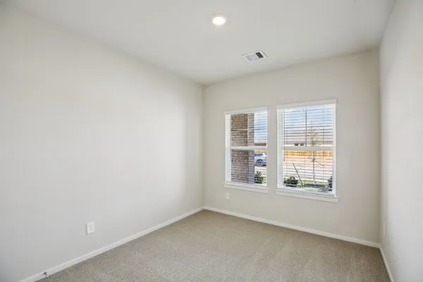 a bedroom with a bed a couch and large window