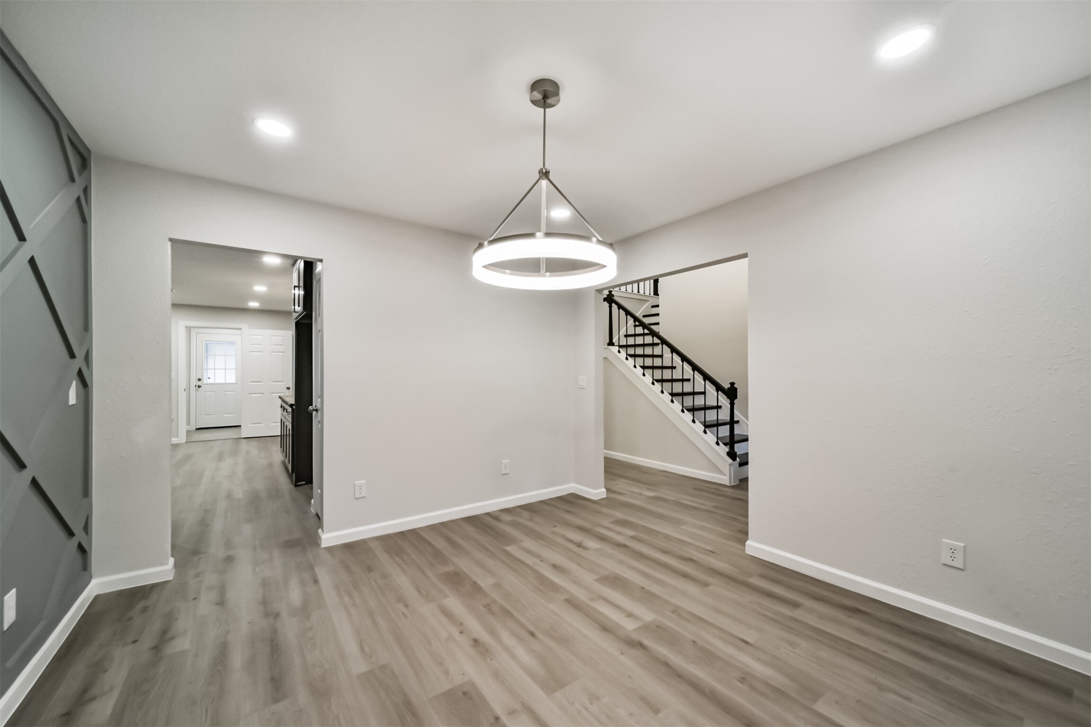 15610 Ripplewind Lane Houston, TX 77068 - Photo 16 of 44 a view of a room with wooden floor staircase and a ceiling fan