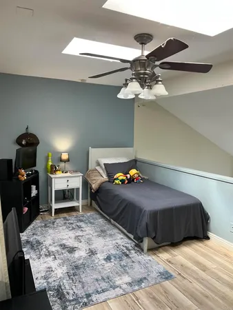 a bedroom with a bed and a chandelier