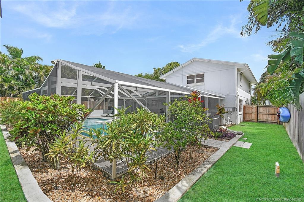 4729 Southeast Glen Ridge Trail Stuart, FL 34997 - Photo 26 of 81 a front view of a house with a yard