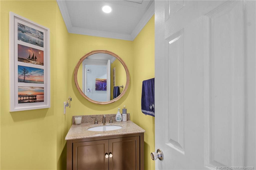 4729 Southeast Glen Ridge Trail Stuart, FL 34997 - Photo 42 of 81 a bathroom with a sink and a mirror