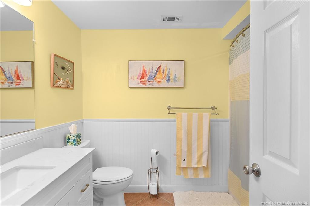 4729 Southeast Glen Ridge Trail Stuart, FL 34997 - Photo 49 of 81 a bathroom with a toilet a sink and a window