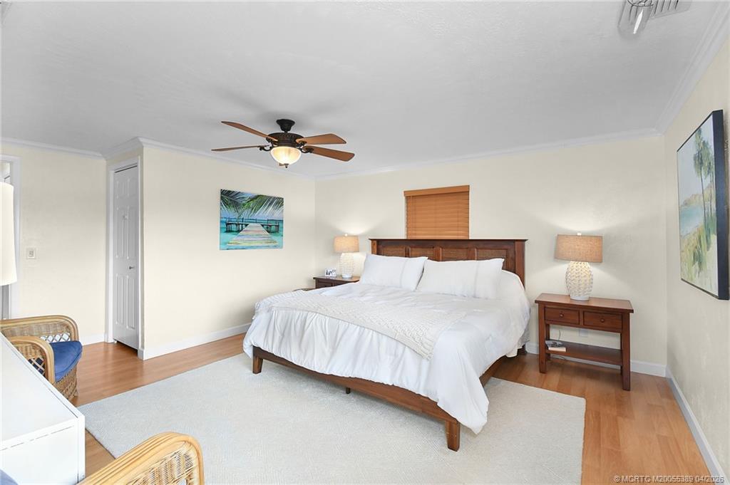4729 Southeast Glen Ridge Trail Stuart, FL 34997 - Photo 55 of 81 a bedroom with a bed furniture and a potted plant