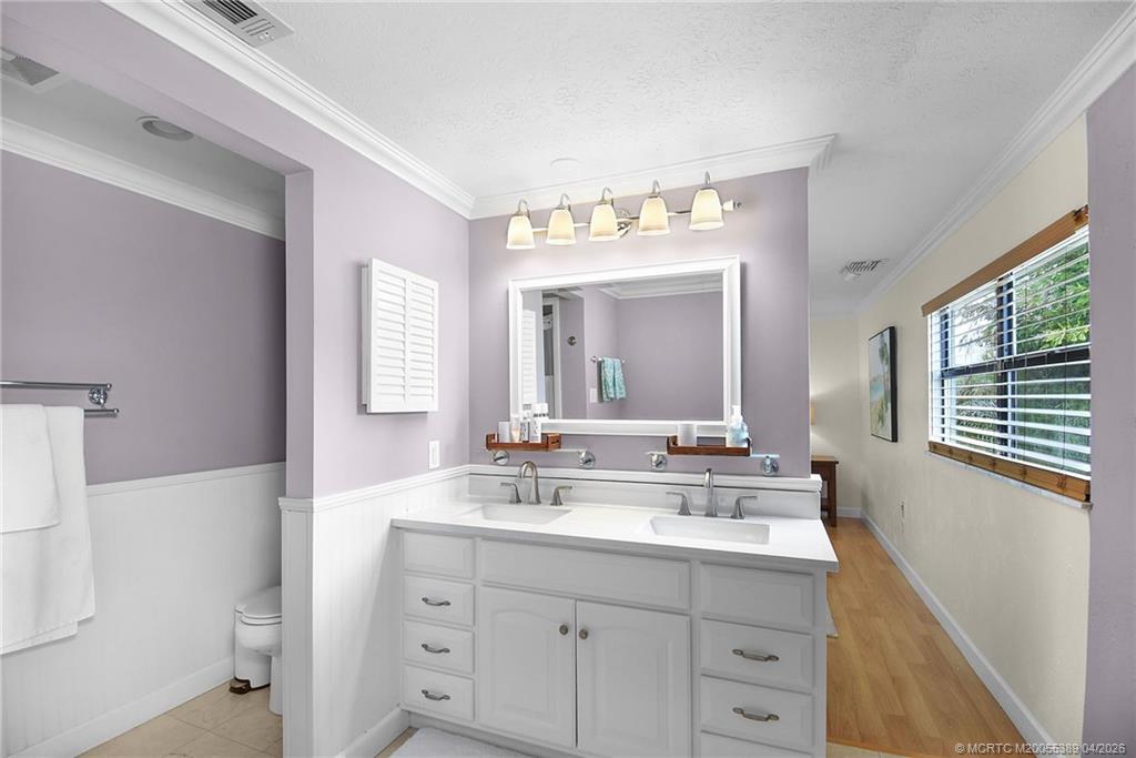 4729 Southeast Glen Ridge Trail Stuart, FL 34997 - Photo 57 of 81 a bathroom with a double vanity sink and a mirror