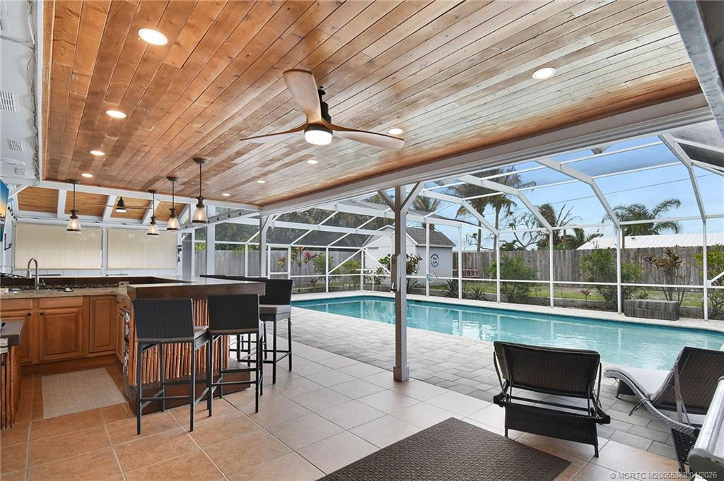 4729 Southeast Glen Ridge Trail Stuart, FL 34997 - Photo 10 of 81 a wooden bench sitting in a roof