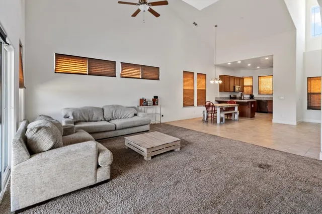 a living room with furniture and a dining table with window