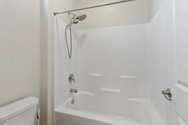 a bathroom with a bath tub with a shower