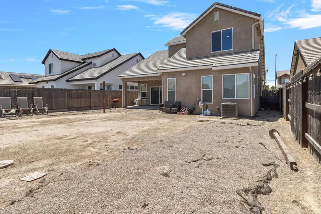 a view of a house with a yard covered in snow