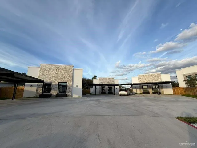 a view of a building with cars parked