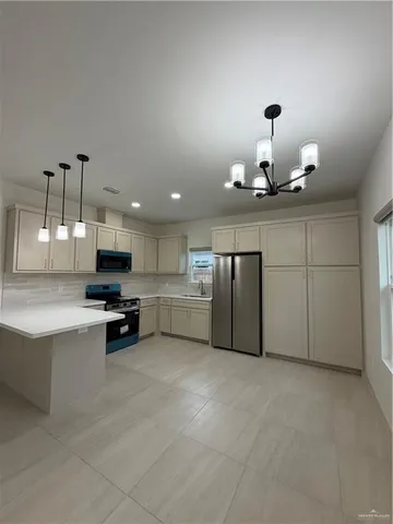 a view of a kitchen with a sink and a stove top oven