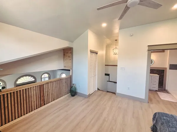 a view of a hallway view with wooden floor and staircase