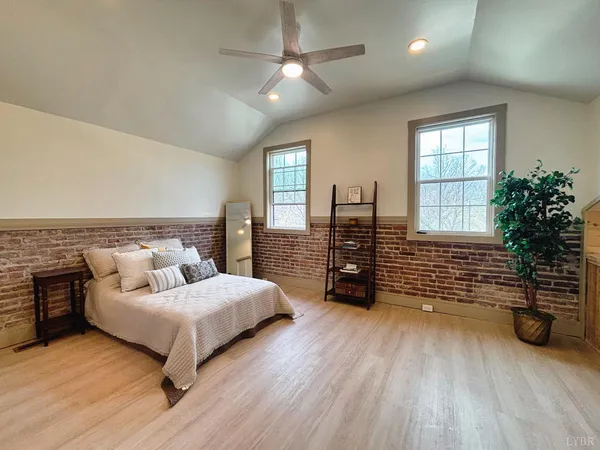 a bedroom with furniture and wooden floor