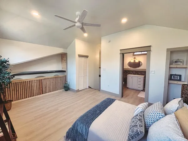 a bedroom with a large bed and a chandelier