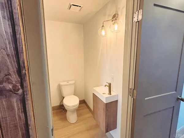a bathroom with a toilet a sink and a mirror