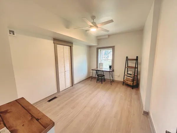 a view of a livingroom with a hardwood and a ceiling fan