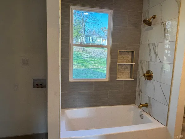 a bath tub sitting next to a window