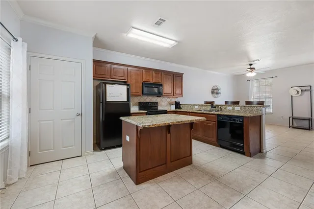 a kitchen with a cabinets and a stove top oven