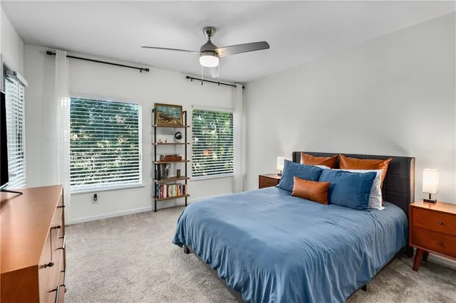 a bedroom with a large bed and a chandelier