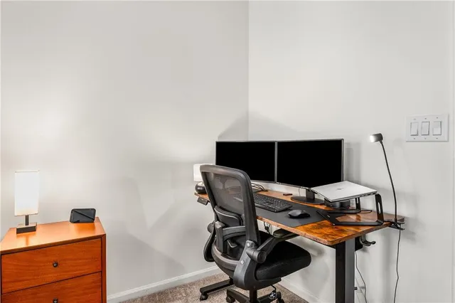 a view of workspace with wooden floor windows