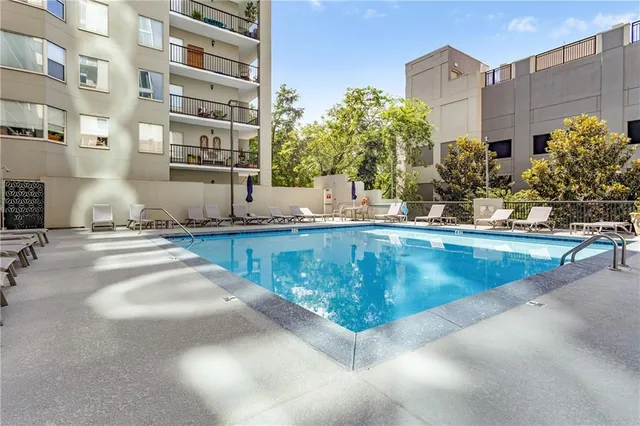 a view of a swimming pool with a lawn chairs and a lawn chair