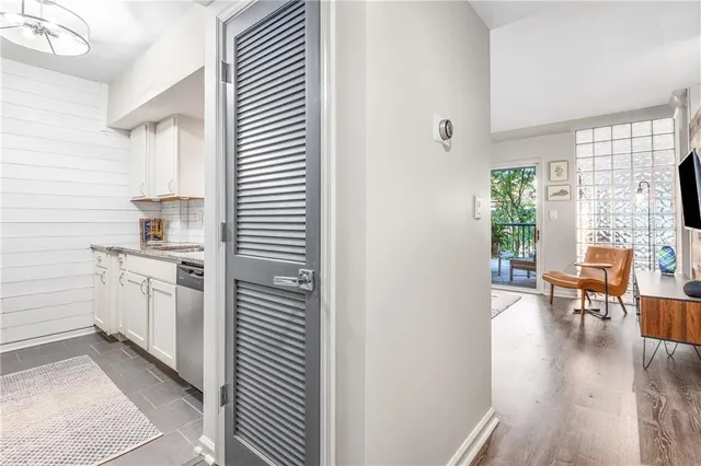 a kitchen with white cabinets and white appliances