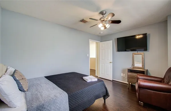 a bedroom with a large bed and a chandelier