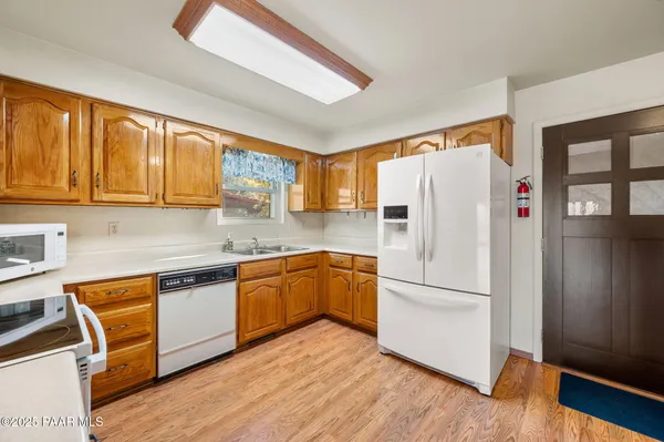 a kitchen with stainless steel appliances granite countertop a refrigerator sink and cabinets