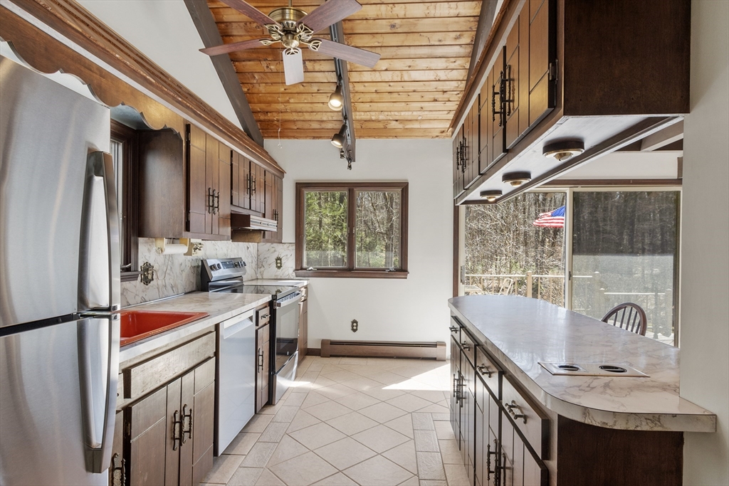 22 Briggs Road Petersham, MA 01366 - Photo 26 of 41 a kitchen that has a sink a stove and chairs
