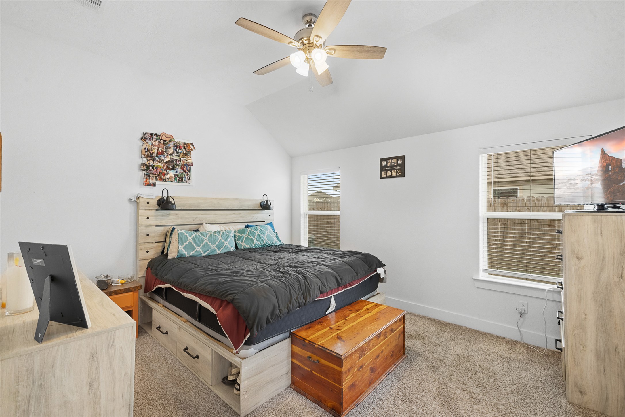 149 Windmill Road Somerville, TX 77879 - Photo 22 of 31 Bedroom featuring vaulted ceiling, light carpet, and a ceiling fan