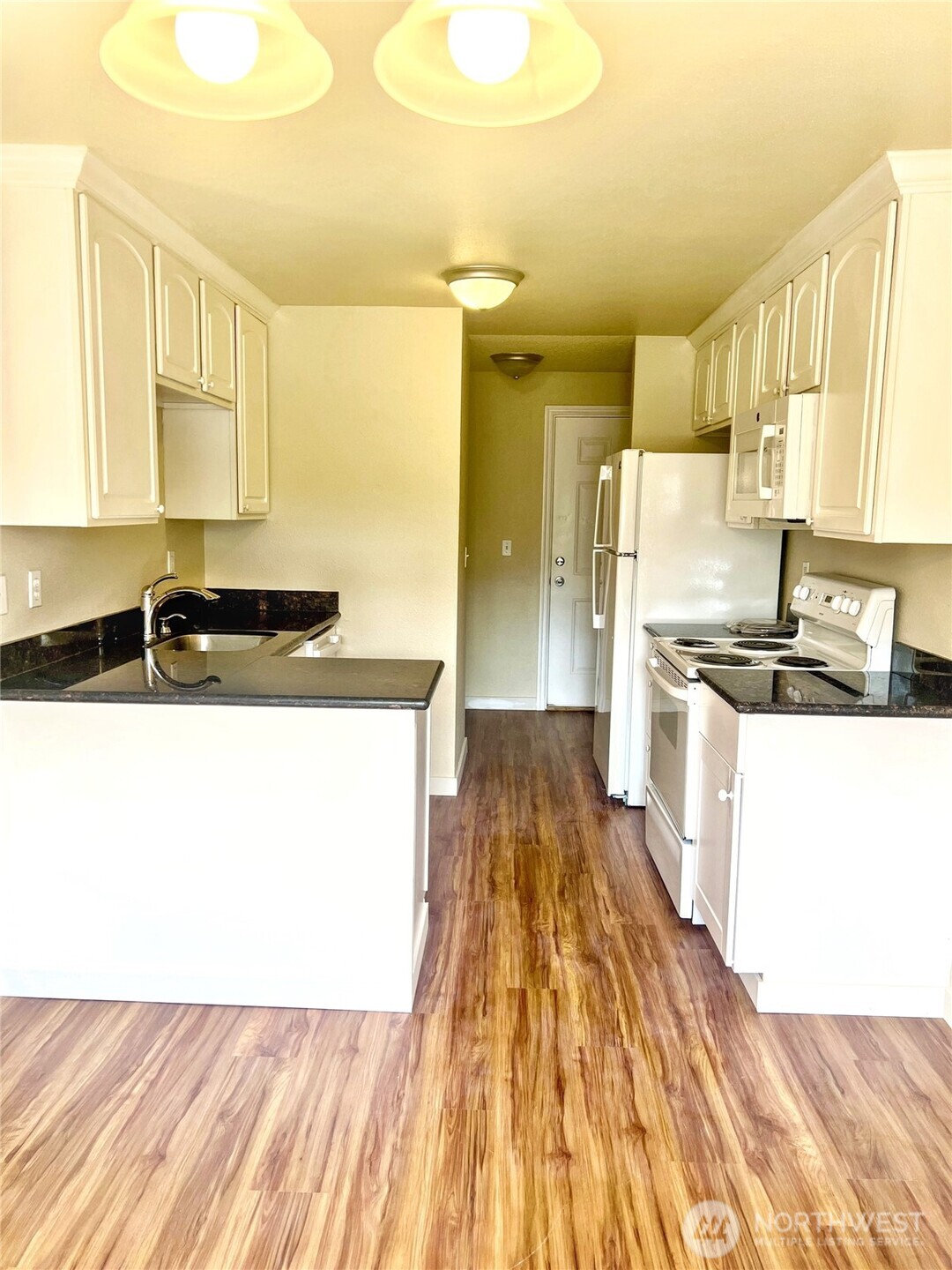 10018 Golden Given Road East, Unit 33 Tacoma, WA 98445 - Photo 2 of 8 a kitchen with a sink a counter top space and appliances