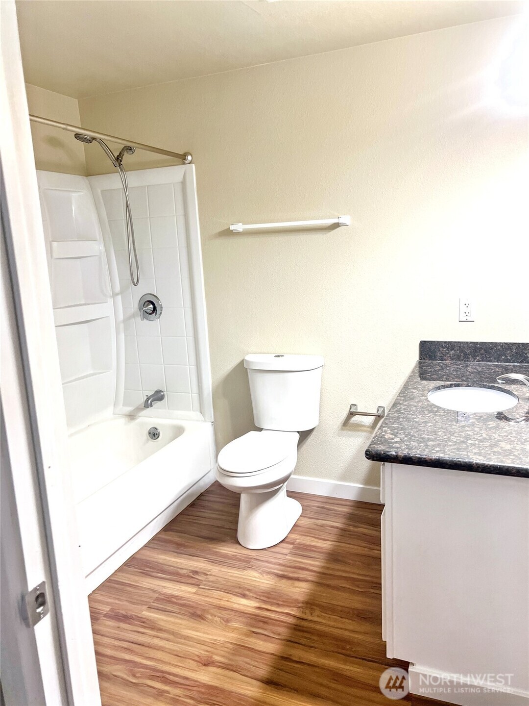 10018 Golden Given Road East, Unit 33 Tacoma, WA 98445 - Photo 6 of 8 a bathroom with a granite countertop bathtub shower sink and toilet