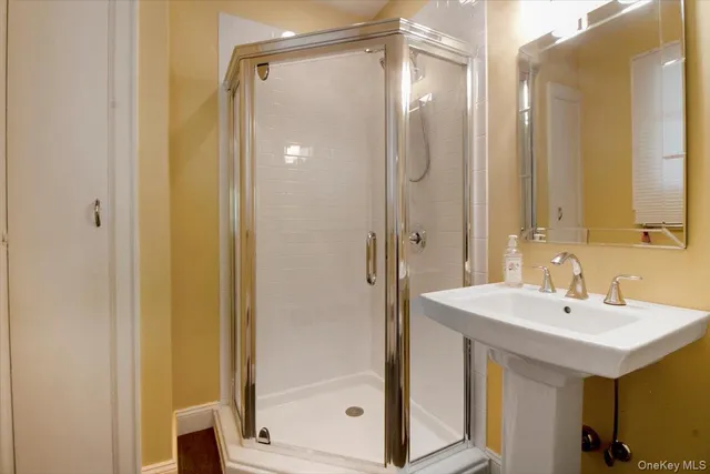 a bathroom with a shower and a sink