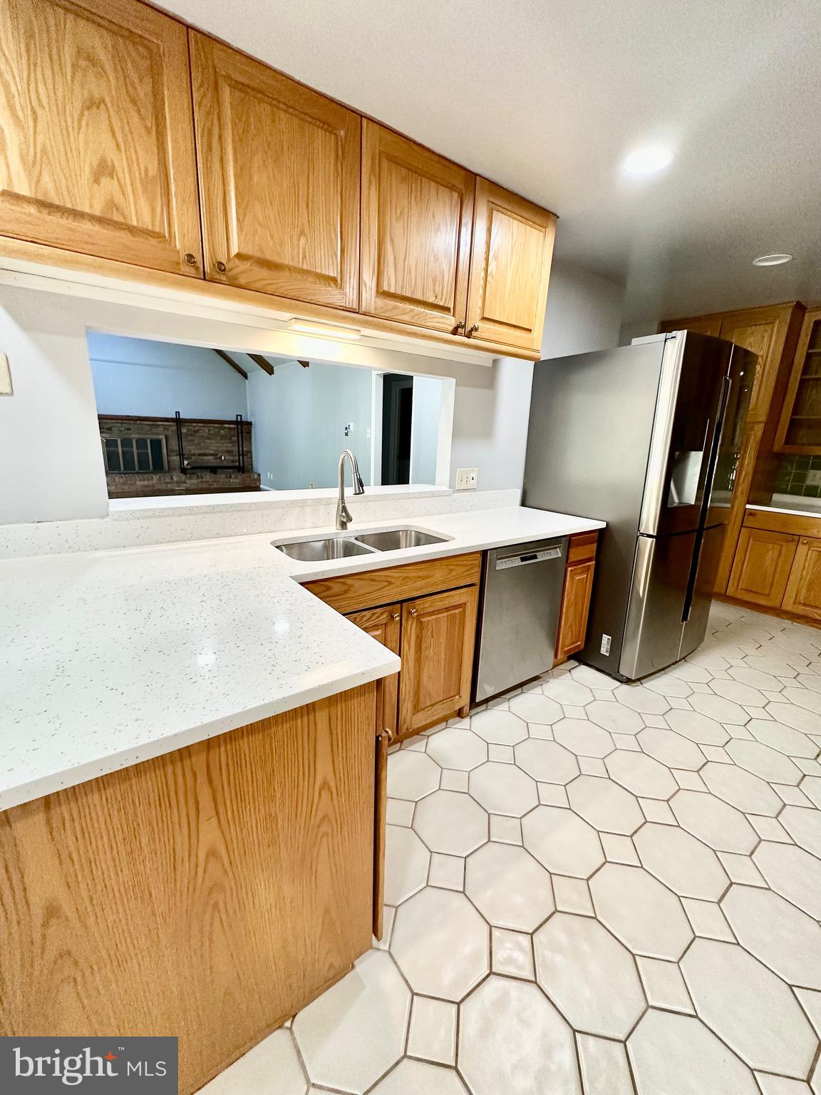12312 Loch Carron Circle Fort Washington, MD 20744 - Photo 28 of 57 a kitchen with stainless steel appliances kitchen island granite countertop a sink a stove white cabinets a dining table and chairs